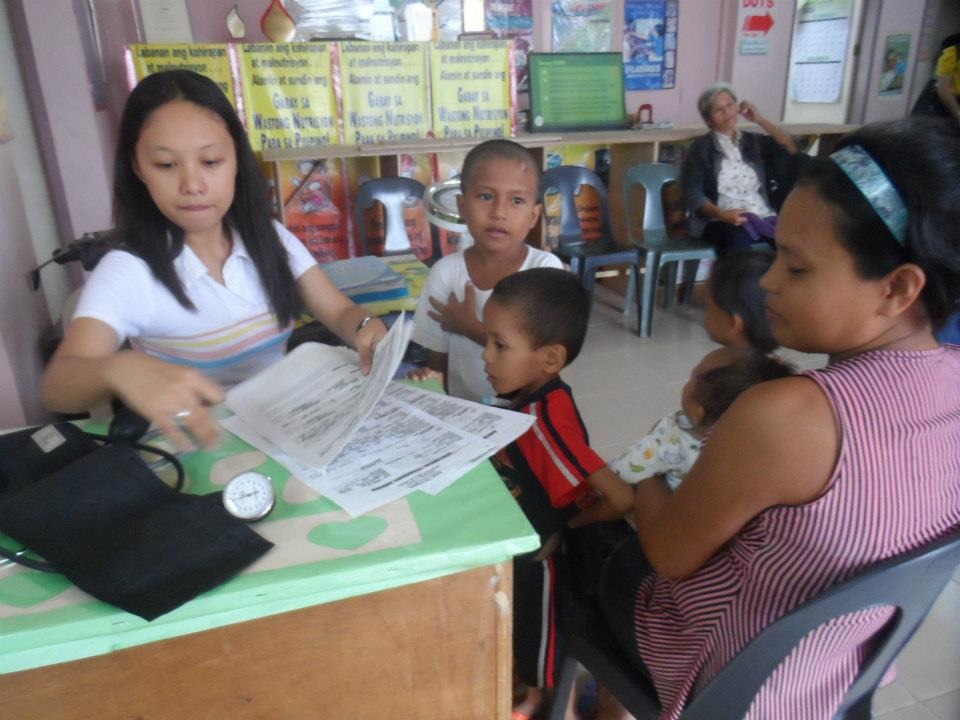 Health worker preparing medical assessment charts for children and mothers