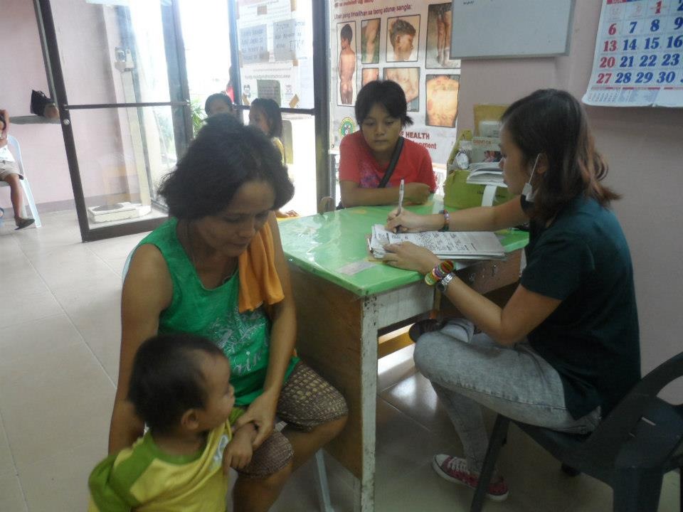 Health worker filling out records during family consultation