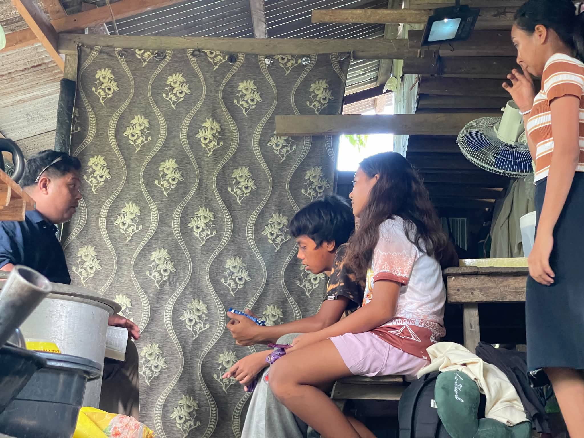 Adults seated closely together inside a home