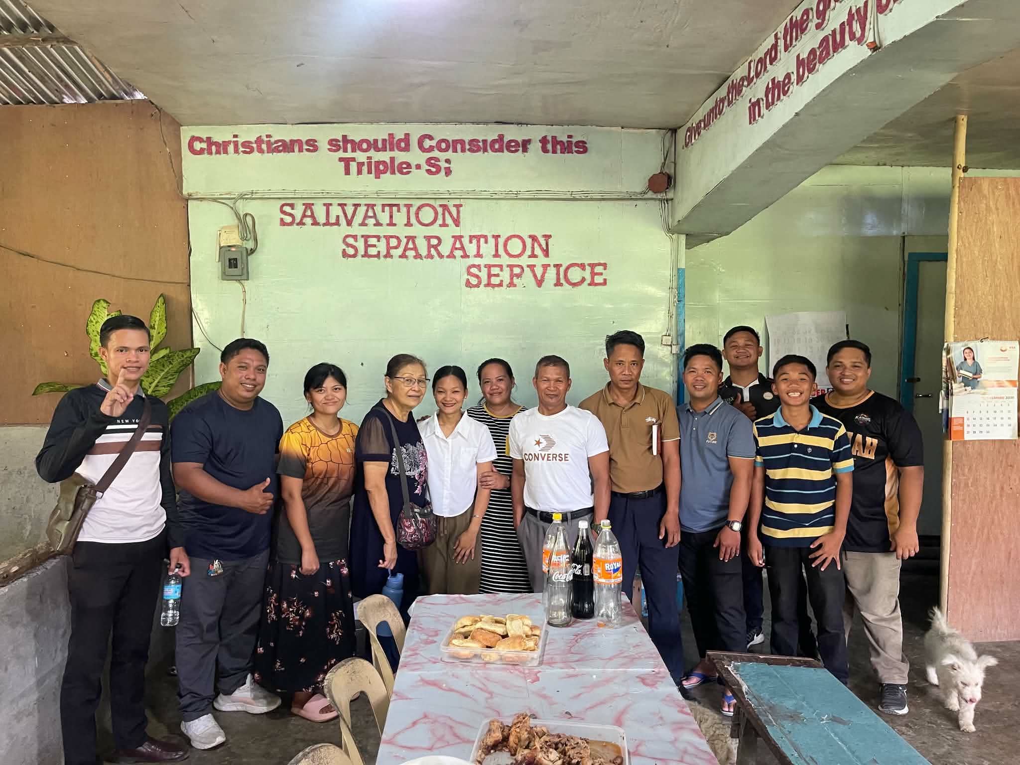 A group gathered behind a table inside a church