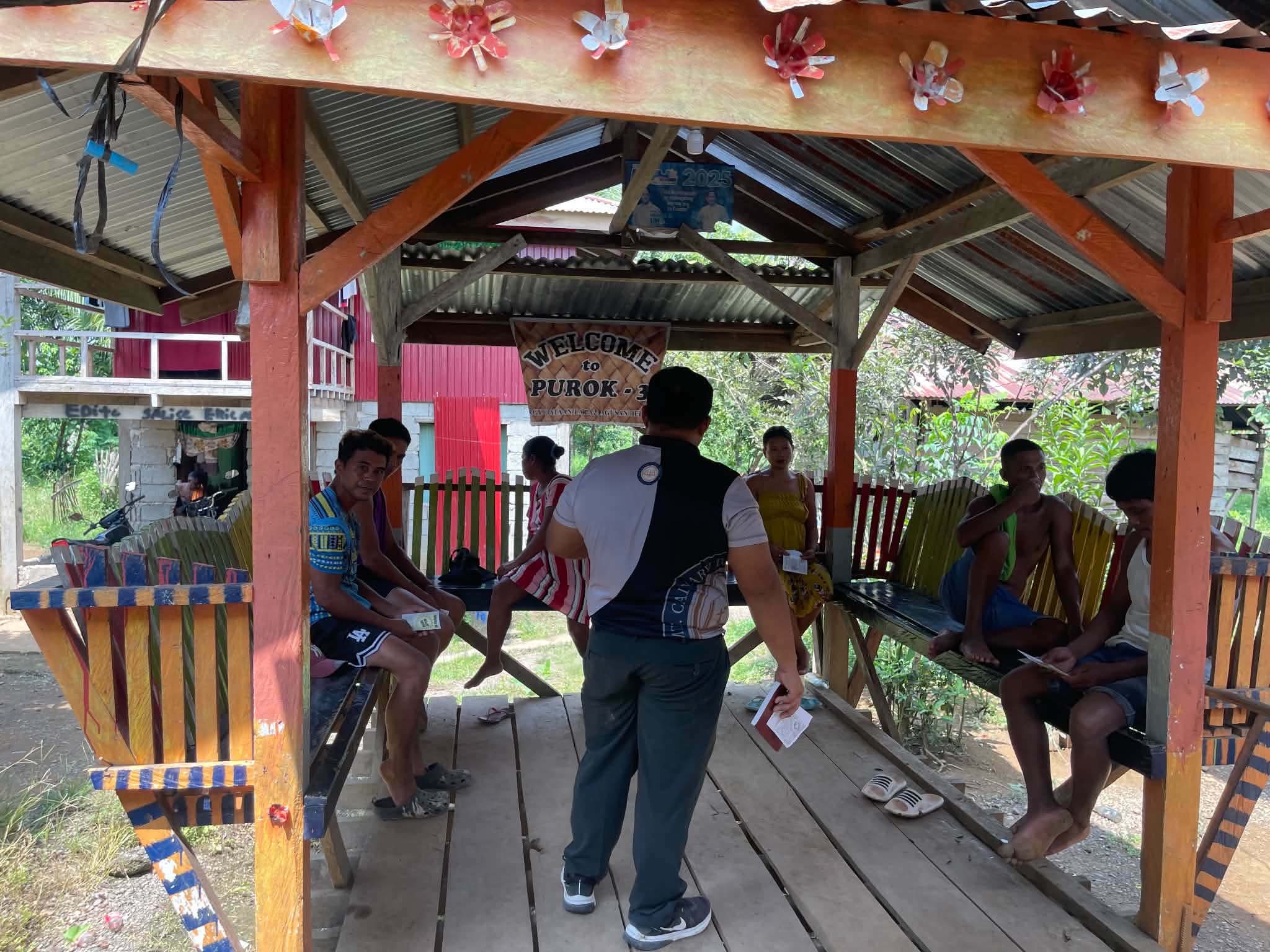 Visitors entering an open wooden gathering space