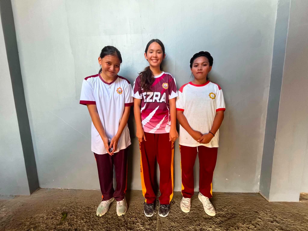 Female students of Ezra Mission Academy standing together proudly in school uniform