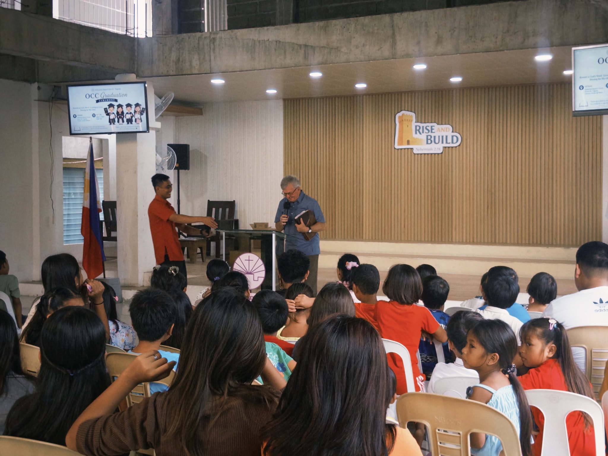Evangelist Chovan preparing to teach with an open Bible at Nehemiah Baptist Church
