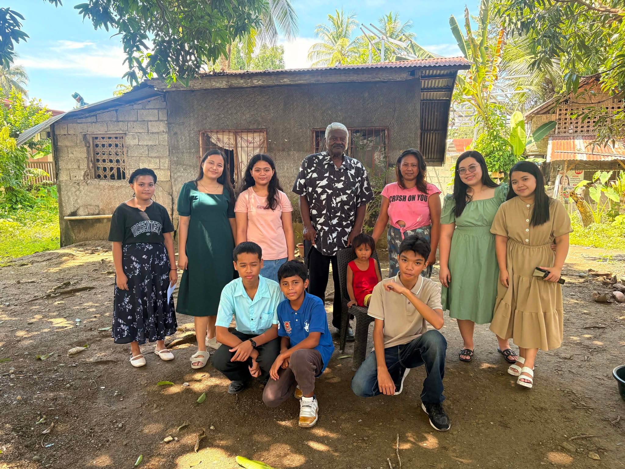 Missionary Henry Walker with older students and teachers in a rural community